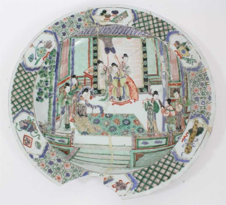Lot 149 - Chinese Kangxi period famille verte dish, painted with an interior scene with figures and attendants, the border with panels of precious objects on a patterned ground, 37.5cm diameter 
Provenance:...