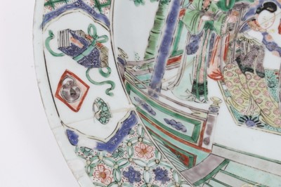 Lot 149 - Chinese Kangxi period famille verte dish, painted with an interior scene with figures and attendants, the border with panels of precious objects on a patterned ground, 37.5cm diameter 
Provenance:...