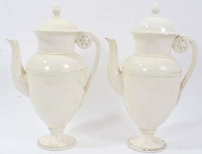 Lot 157 - Pair of 19th century creamware coffee pots, the handles with flower and leaf terminals, the covers with acorn finials, 30.5cm and 31cm high