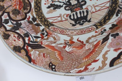 Lot 160 - A large Japanese Imari Charger, Edo period, 17th/18th century, the centre decorated with a vase of flowers, bordered by exotic birds and foliate patterns, 53.5cm diameter, together with a 19th cent...