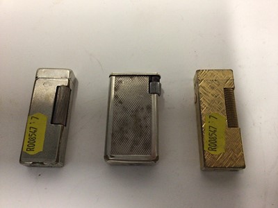 Lot 2252 - Two vintage Dunhill pocket lighters together with another (3)