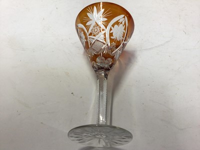 Lot 64 - Bohemian amber cut glass decanter and stopper, of tapered form with Continental white metal mount, together with four matching glasses (5)