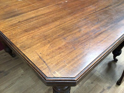 Lot 329 - Edwardian wind-out extending dining table with two extra leaves on turned legs terminating on ceramic castors