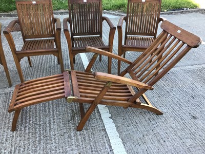 Lot 362 - Four teak garden chairs, together with a teak garden lounger and cushion