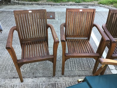 Lot 362 - Four teak garden chairs, together with a teak garden lounger and cushion
