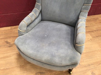 Lot 317 - Victorian easy chair upholstered in pale blue Drayson, on turned legs with brass castors.