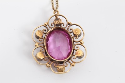 Lot 79 - Early 20th century 18ct gold pink stone and seed pearl pendant with an oval mixed cut pink stone, possibly a pink topaz, mounted in an open work flower shaped setting set with six seed pearls, on 1...