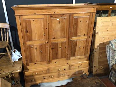 Lot 9 - Modern pine triple wardrobe wiht three panelled doors, three short and two long drawers below, 184cm wide x 59cm deep x 199cm high plus a pine four door wardrobe and a cheval mirror