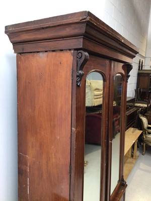 Lot 11 - Victorian mahogany double wardrobe with two arched mirror doors and drawer below, 127cm wide x 57cm deep x 211cm high