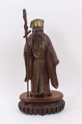 Lot 88 - Antique Japanese bronze figure, signed on the back, on a carved wooden stand