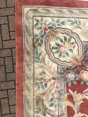 Lot 60 - Large Chinese was rug with floral decoration on terracotta and cream ground 367cm x 470cm