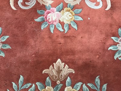 Lot 60 - Large Chinese was rug with floral decoration on terracotta and cream ground 367cm x 470cm
