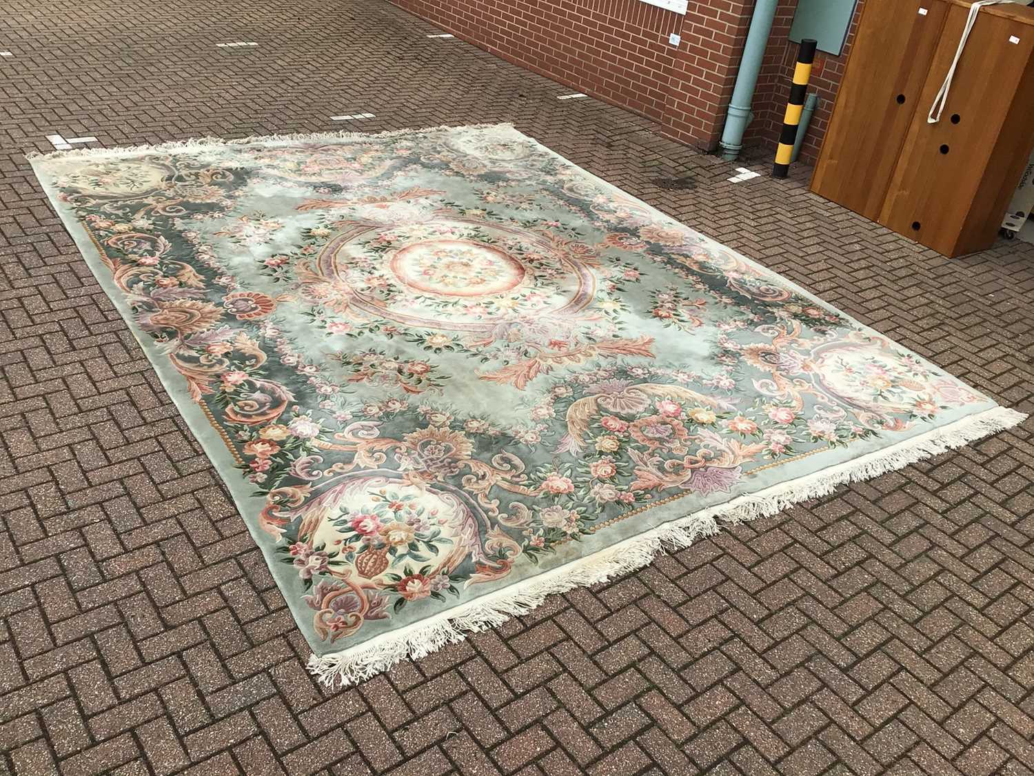 Lot 61 - Large Chinese rug with floral decoration on green and cream ground 369cm x 463cm