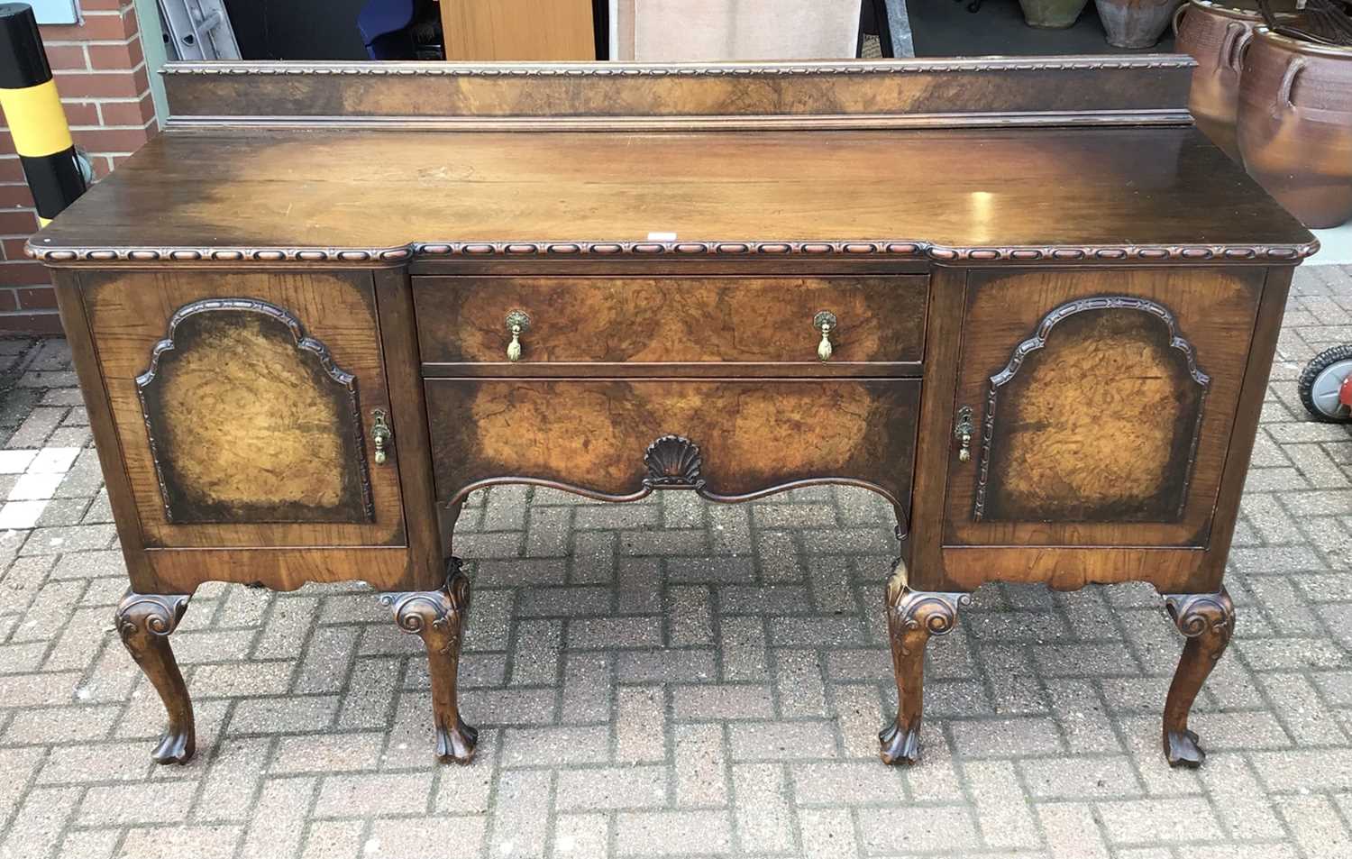 Lot 62 - Good quality walnut sideboard with raised ledge back, two central drawers below flanked by cupboards on carved cabriol legs 183cm wide x 58cm deep x 110cm high