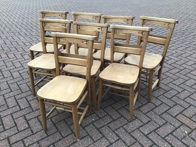 Lot 65 - Pine dining table on square legs 198cm wide x 88cm deep x 77cm high with a set of eight pine chapel chairs