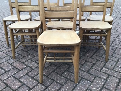 Lot 65 - Pine dining table on square legs 198cm wide x 88cm deep x 77cm high with a set of eight pine chapel chairs