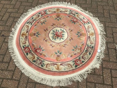 Lot 66 - Chinese wash rug with floral decoration on peach ground 274cm x 186cm with a smaller round rug of similar description 134cm
