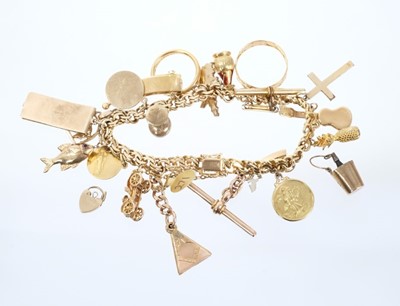 Lot 644 - Gold charm bracelet with charms