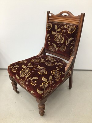 Lot 41 - Edwardian walnut framed easy chair with upholstered seat and back on turned front legs and castors