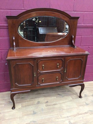 Lot 340 - 1920's mahogany sideboard with raised bevelled mirror back, two central drawers below flanked by cupboards on cabriole legs, 136cm wide, 51cm deep, 165cm high