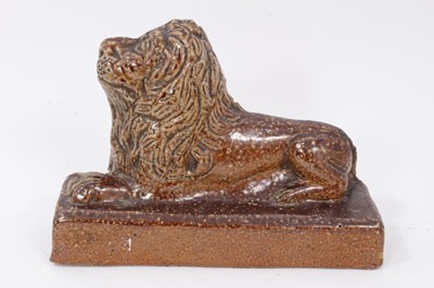Lot 192 - 19th century salt glazed stoneware pottery door stop in the form of a lion, 18.5cm wide x 12.5cm high, and a further salt glazed model of a lion (2)