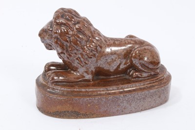 Lot 192 - 19th century salt glazed stoneware pottery door stop in the form of a lion, 18.5cm wide x 12.5cm high, and a further salt glazed model of a lion (2)