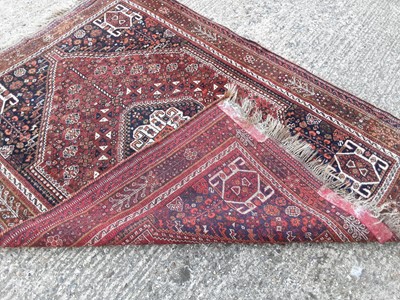 Lot 394 - Eastern rug with geometric decoration on red and blue ground, 199cm x 148cm