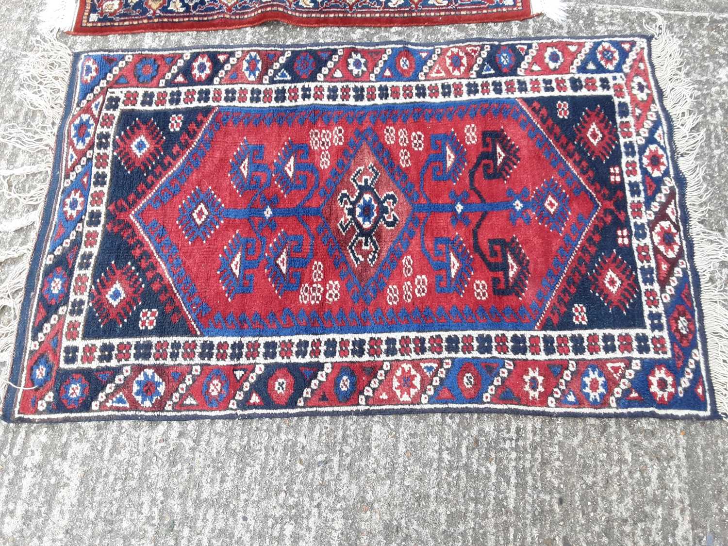 Lot 397 - Two Eastern rugs with geometric decoration on red and blue ground, 113cm x 72cm and 97cm x 62cm