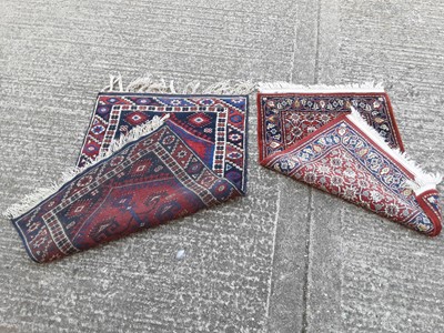 Lot 397 - Two Eastern rugs with geometric decoration on red and blue ground, 113cm x 72cm and 97cm x 62cm