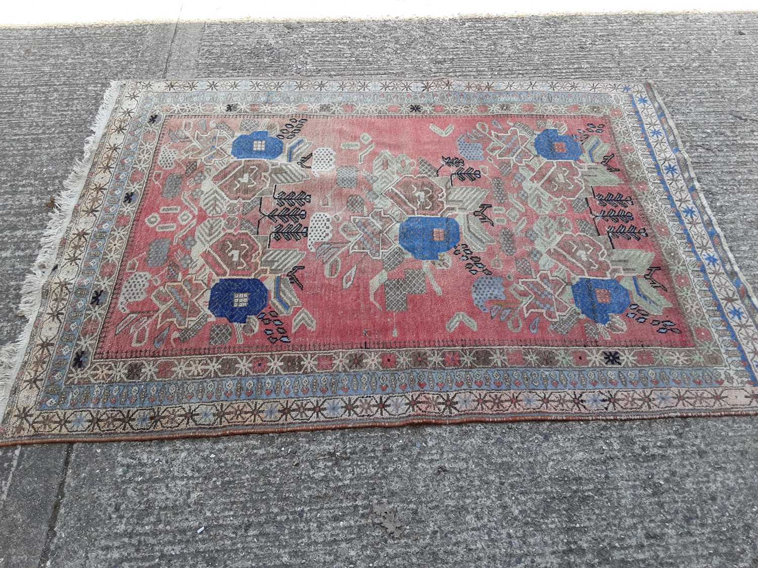 Lot 398 - Eastern rug with geometric decoration on red, blue and beige ground, 207cm x 146cm