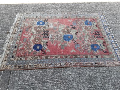 Lot 398 - Eastern rug with geometric decoration on red, blue and beige ground, 207cm x 146cm