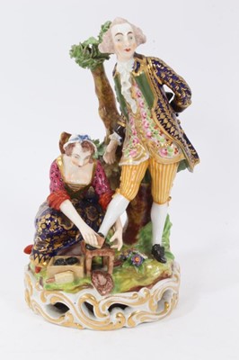 Lot 210 - Derby group of the 'shoe black', c.1820, the figures on a grassy mound on top of a round gilt scrollwork base, inscribed mark and incised model number to base, 17.5cm high