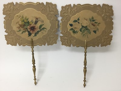 Lot 131 - Pair of early 19th century face screens, each with turned giltwood handle