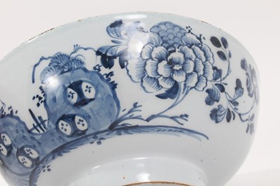 Lot 222 - 18th century English blue and white delftware bowl, painted with flowers in the Oriental style, 22.5cm diameter