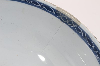 Lot 222 - 18th century English blue and white delftware bowl, painted with flowers in the Oriental style, 22.5cm diameter