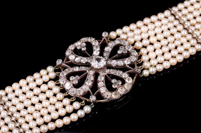 Lot 525 - Diamond and cultured pearl choker necklace, the diamond openwork plaque with a four-leaf clover design centred with a principal old cut diamond estimated to weigh approximately 1.2cts, with old cut...