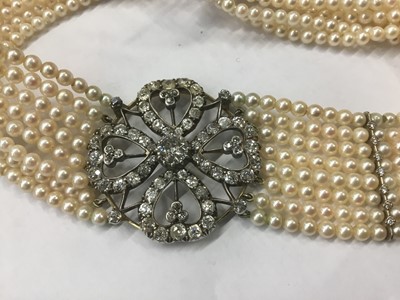 Lot 525 - Diamond and cultured pearl choker necklace, the diamond openwork plaque with a four-leaf clover design centred with a principal old cut diamond estimated to weigh approximately 1.2cts, with old cut...