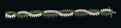 Lot 529 - Good quality emerald and diamond bracelet of cross-over design with two articulated platted rows of round mixed cut emeralds and brilliant cut diamonds in 18ct white and yellow gold claw setting. E...