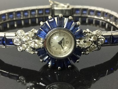 Lot 533 - 1950s/1960s ladies Omega diamond and sapphire cocktail wristwatch, the circular dial with concealed winding crown, tapered baguette cut sapphires and diamond lugs with marquise and brilliant cut di...
