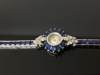 Lot 533 - 1950s/1960s ladies Omega diamond and sapphire cocktail wristwatch, the circular dial with concealed winding crown, tapered baguette cut sapphires and diamond lugs with marquise and brilliant cut di...