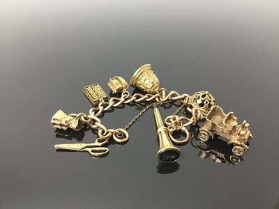 Lot 539 - Gold charm bracelet with various gold and yellow metal charms