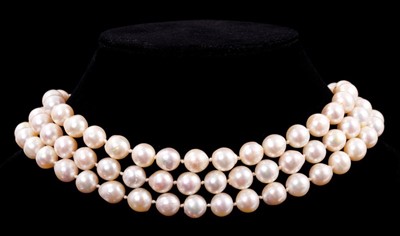 Lot 542 - Cultured pearl three-strand choker with three strings of baroque cultured pearls measuring approximately 8.5mm diameter on a large 14k gold and cultured pearl clasp.