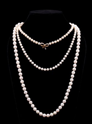 Lot 544 - Three single stand cultured pearl necklaces, one with a string of 8mm cultured pearl with a diamond cluster clasp, 65cm, another with diamond bow and gold clasp, 34cm and one other 43cm.