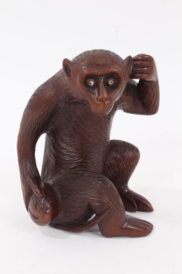 Lot 935 - Japanese carved wooden okimono of a monkey holding a gourd, 10cm high