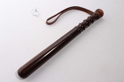 Lot 878 - 20th century turned wood police truncheon with ribbed grip and brown leather strap stamped Hiatt's. B.ham, named in ink W. H. La Touche, 38cm in length