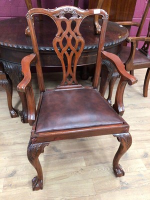 Lot 409 - 1920's mahogany oval dining table with gadrooned edge on carved cabriole legs and claw and ball feet, 128cm x 107cm, and a set of four matching elbow chairs with pierced vase shape splat backs