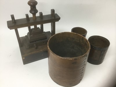 Lot 2386 - Three antique bentwood grain measures, together with a miniature Welsh oak flower press