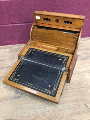Lot 411 - 1920's oak stationery desk cabinet with tambour front, fold out leather lined writing slope and drawer below