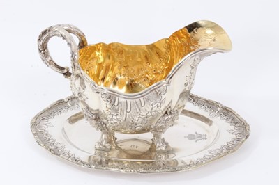 Lot 33 - Late 19th/early 20th Century German Silver Sauce Boat, from the Royal Prussian Collection, of oval form with reeded border, repousse and chased with rocaille, flowers and foliage, with bifurcated f...