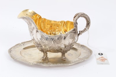 Lot 34 - Late 19th Century German Silver Sauce Boat, from the Royal Prussian Collection, of oval form with reeded border, repousse and chased with rocaille, flowers and foliage, with bifurcated foliage-capp...